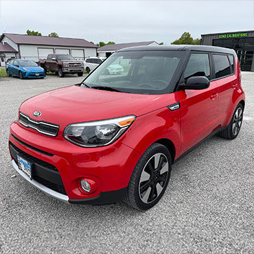 Side of red Kia Sol after collision repair