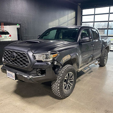 Charcoal gray Toyota truck before collision repair with damaged front bumper