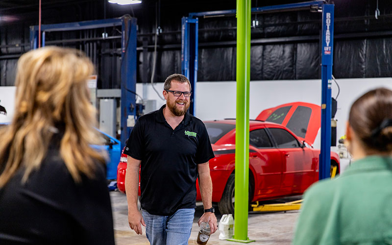 Lander's employee walking through garage with big smile