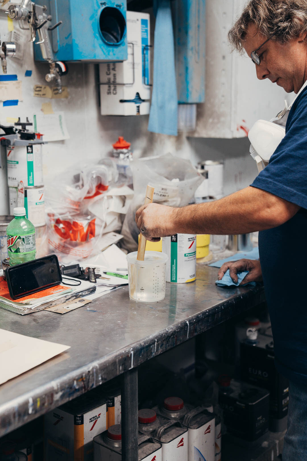 Close up of automotive painter mixing up paints