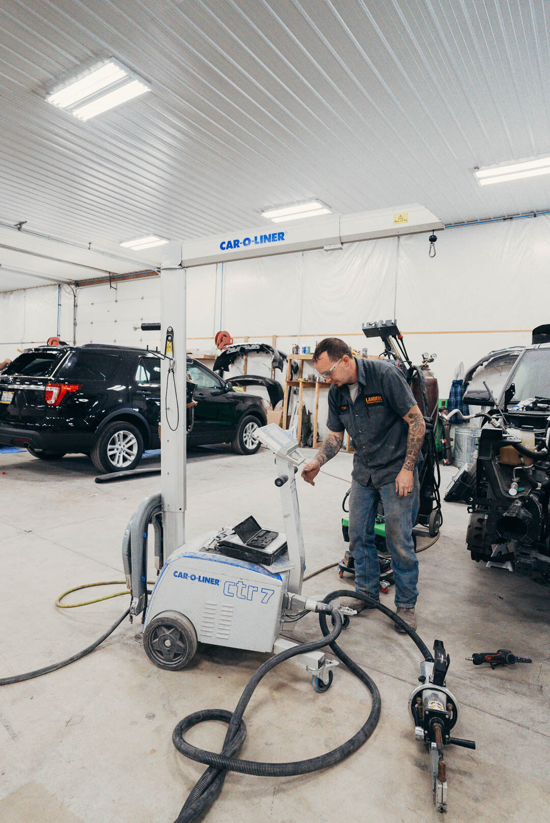 Lander's automotive employee working a Car-o-liner ctr 7 machine