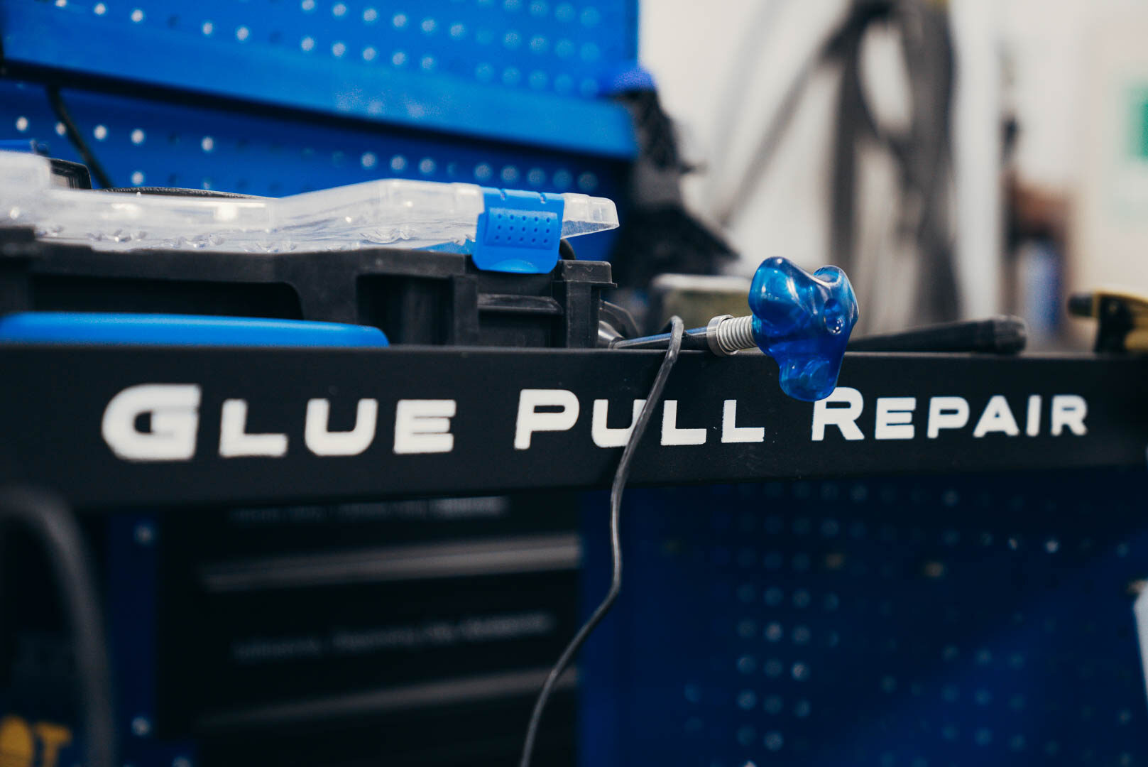 Close up of blue glue pull repair tools
