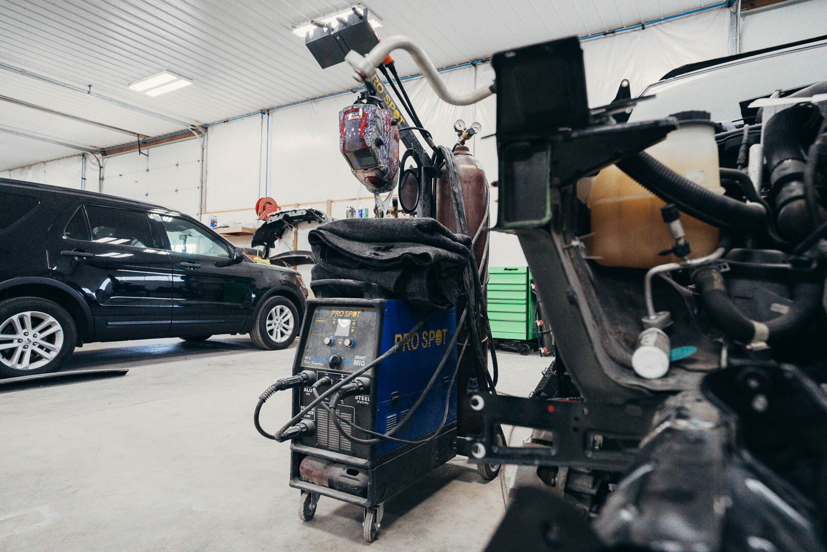 Automotive welding rig set up near vehicle prepared for work