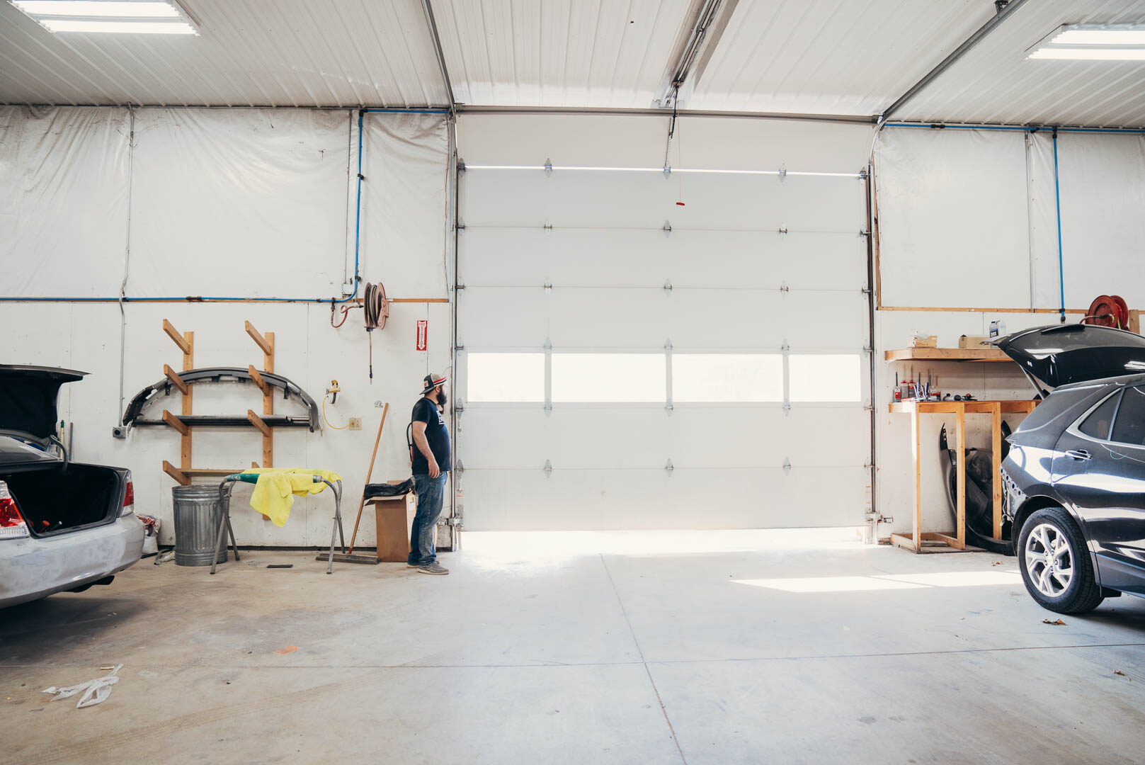 Lander's automotive employee opening up large bay garage door