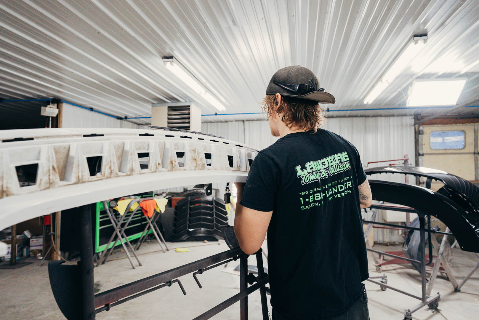 Lander's automotive employee wearing company shirt and black flat bill hat