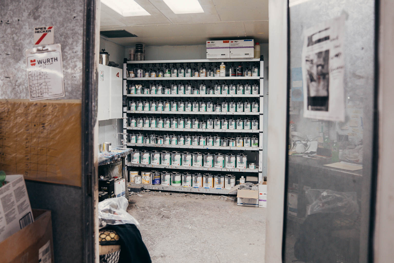 A shelf full of different automotive paints