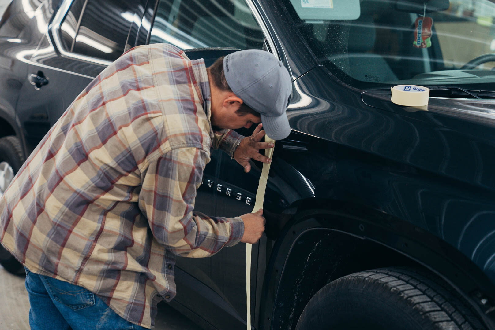 Lander's employee preparing vehicle with masking tape