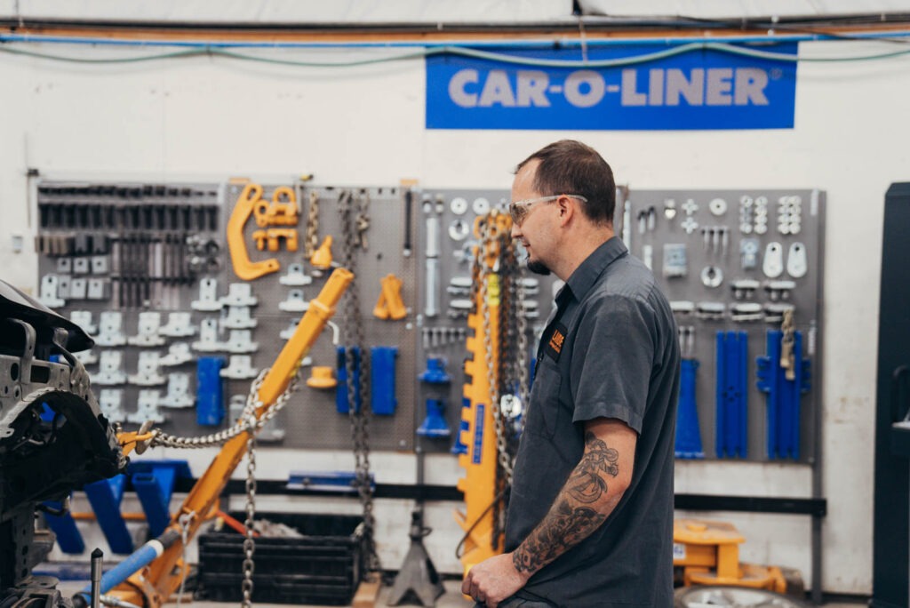 Lander's employee in front of wall of automotive tools for car repair estimates and projects