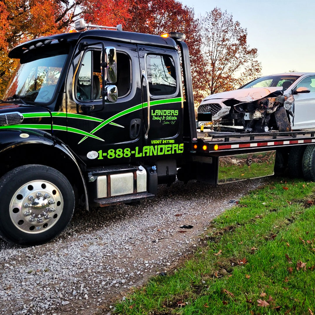 Landers towing and Collision tow truck in the fall