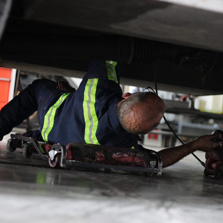 Landers heavy-duty truck mechanic working underneath vehicle