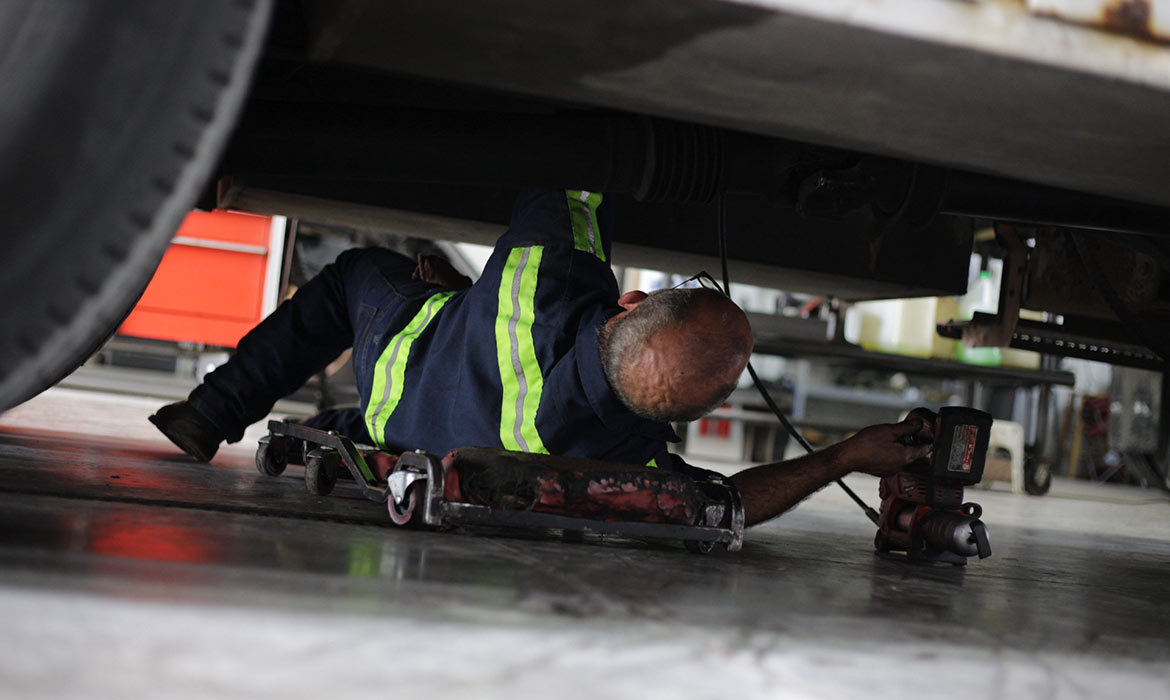 Landers heavy-duty truck mechanic working underneath vehicle