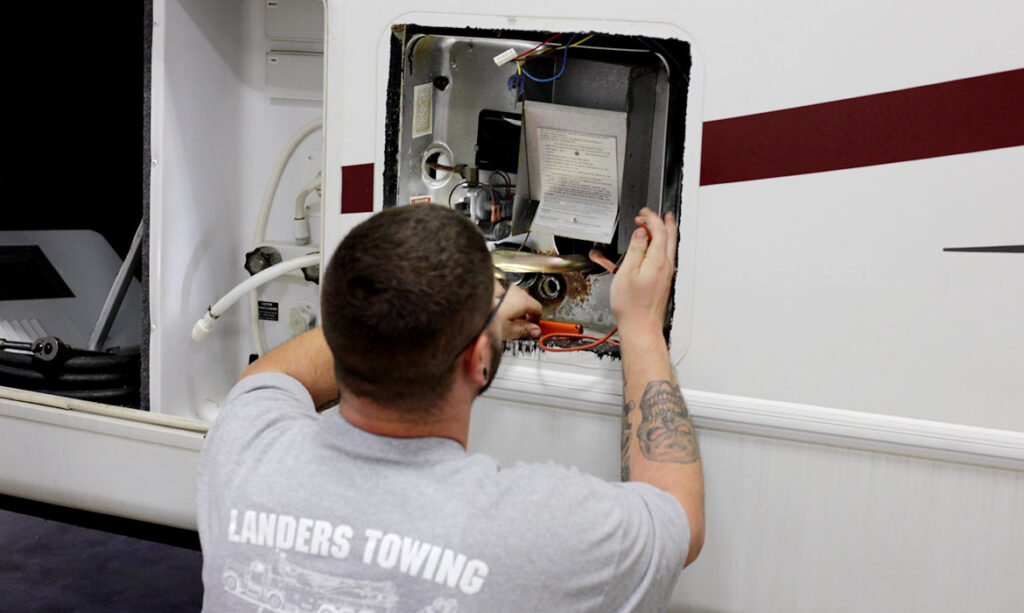 Landers towing mechanic working on RV