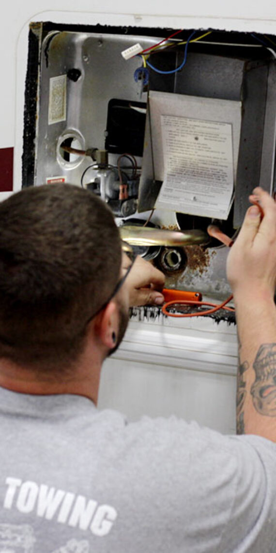 Landers towing mechanic working on RV