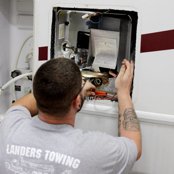 Landers towing mechanic working on RV