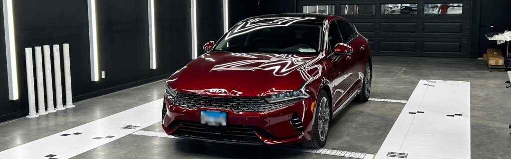 Red Kia in Landers showroom after collision services were completed