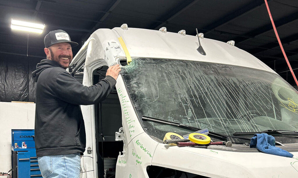 Landers auto mechanic preparing damaged van for collision repair