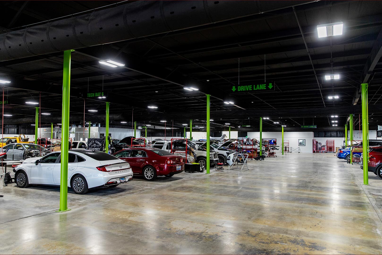 Interior of Lander's auto shop showing rows of vehicles getting worked on